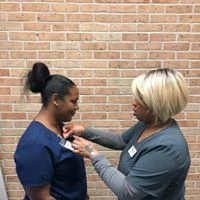 Caregiver being pinned with her “Wings” by care manager, Jennifer Green after she lovingly assisted her client through the end of life process