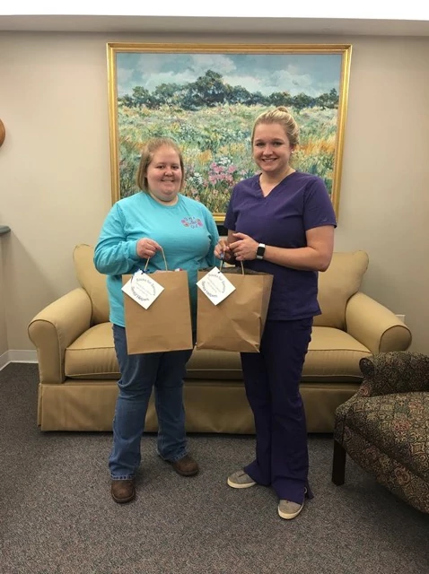 Co-owner Kerianne and Caregiver Tabitha distributing socks the community after Socks for Seniors drive 