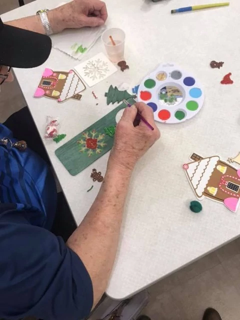 Wesley Common resident enjoying Christmas Crafts with co-owners 