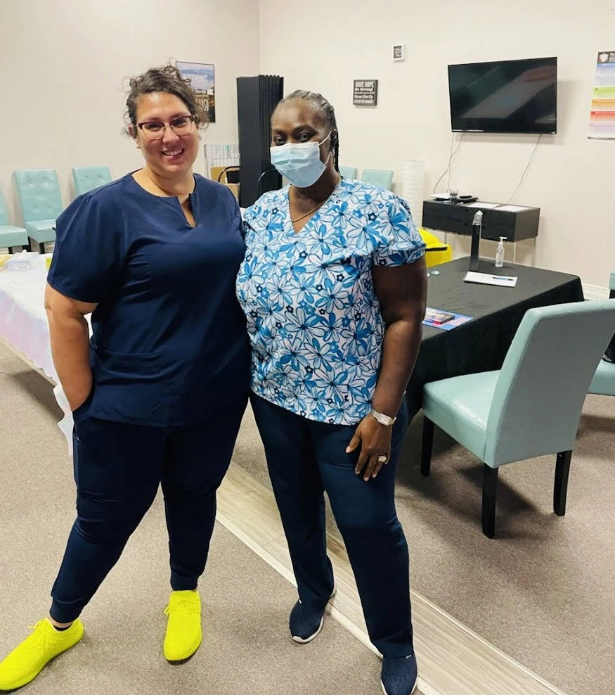 Director of Nursing Elizabeth Velez, R.N. (left) meets with Senior Helpers’ caregiver at the Skills Fair on August 19, 2022, in Winter Park, Florida.