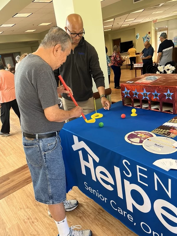 Our care manager Omar enjoyed teaching a fun game of table golf to the seniors at the carnival!